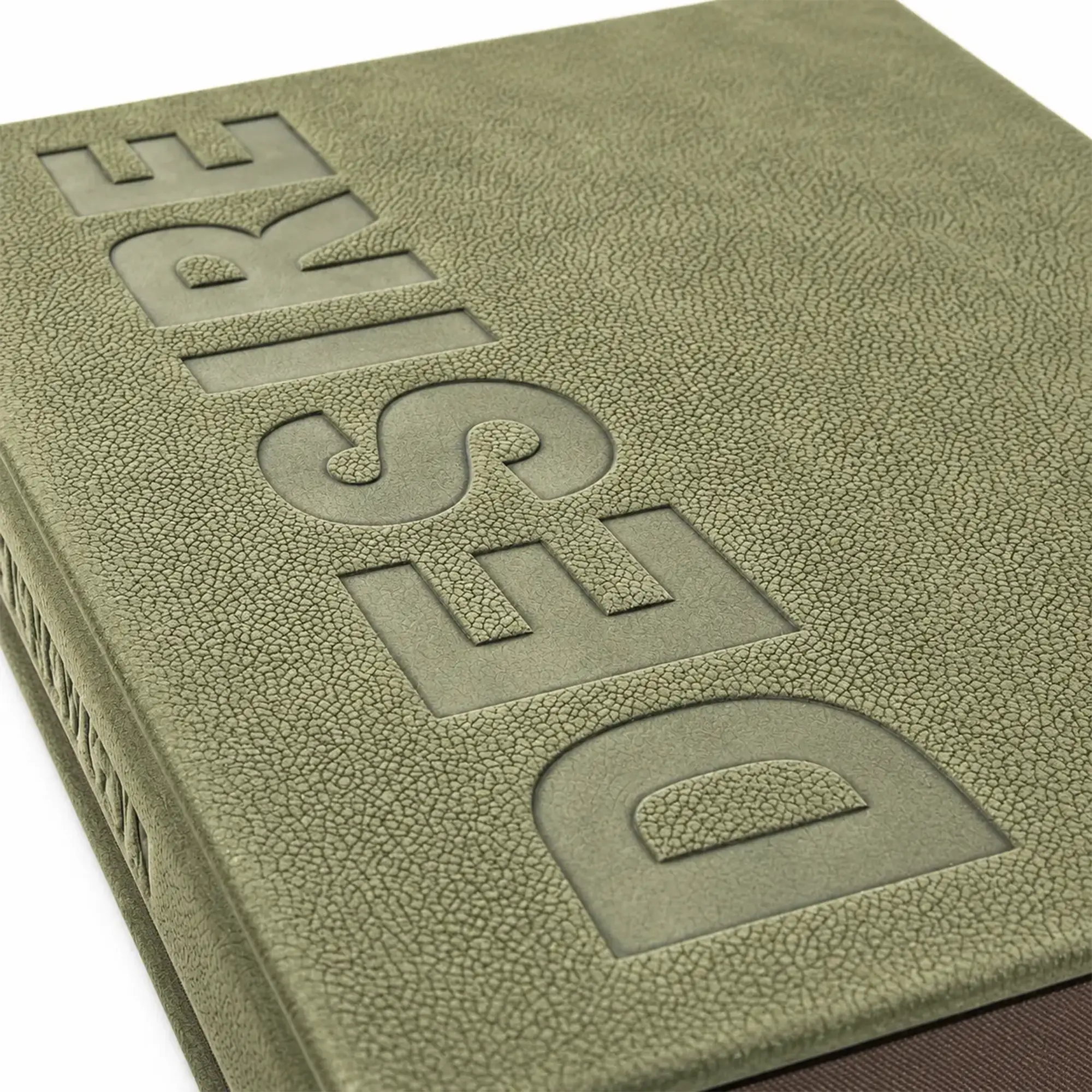 Close-up of The Art Book by KONPOLI in green genuine leather with DESIRE debossed on the cover