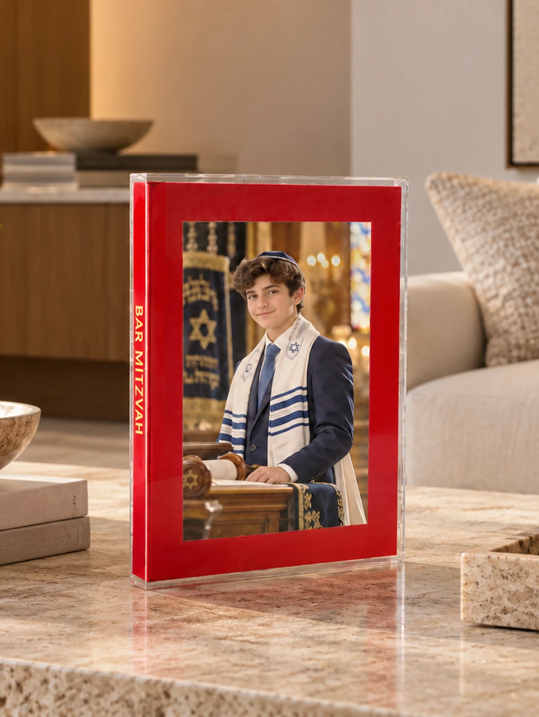 The Art Book by KONPOLI, a bar mitzvah album with a photographic cover, on a living room table